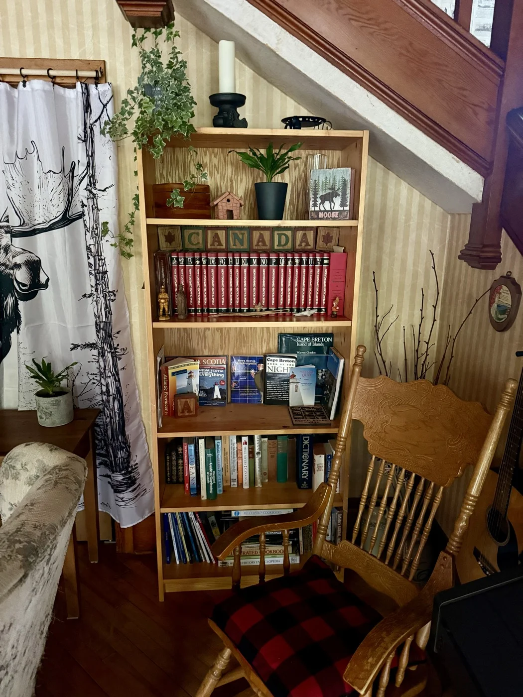 Bookshelf with Cape Breton guides and rocking chair