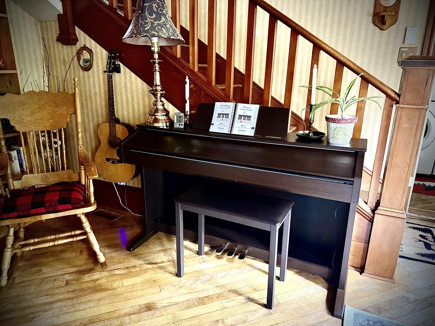 Common room piano and guitar beside the staircase