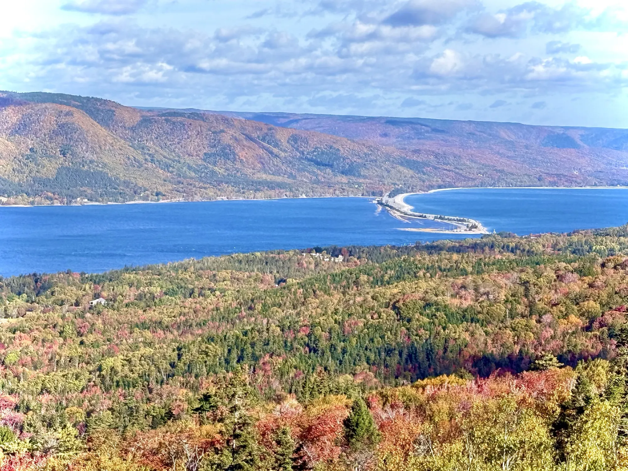 Vibrant autumn forest colour above a Cape Breton lake and causeway