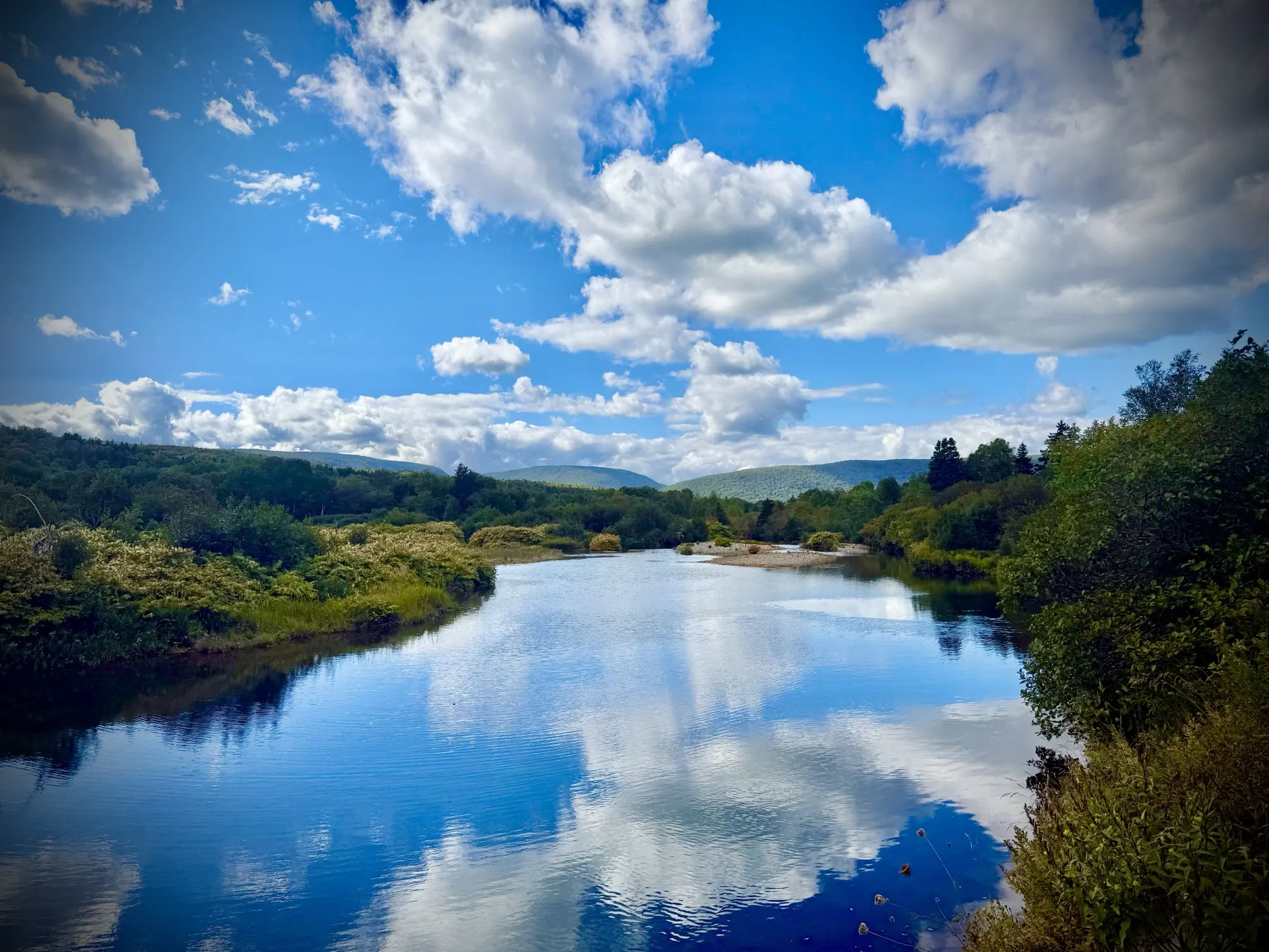 The North River reflecting clouds and the surrounding highlands